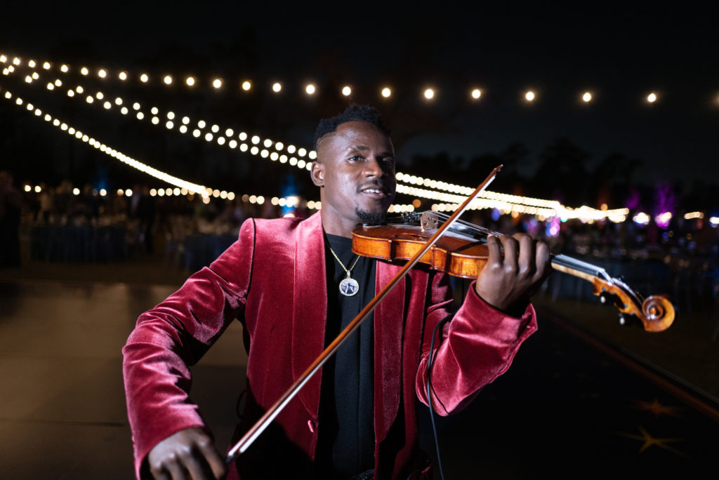 Demola the violinist at Star Light Soiree Picnic for the Park (Photo by Daniel Ortiz Courtesy of Memorial Park Conservancy)