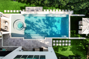 Houston home listing 802 E. Friar Tuck Lane boasts a resort-worthy swimming pool and outdoor living spaces. (Photo by TK Images)