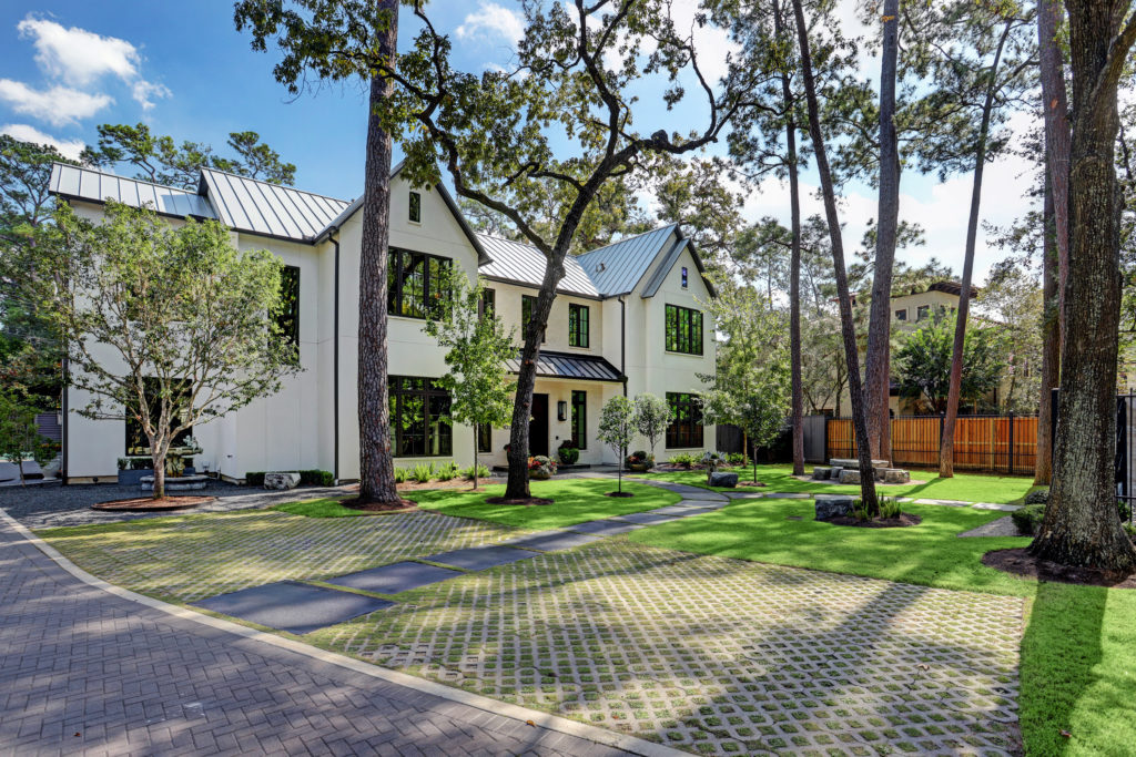 Behind the gates at 802 E. Friar Tuck Lane, a grand mansion rises from a tree-shaded lawn. (Photo by TK Images)
