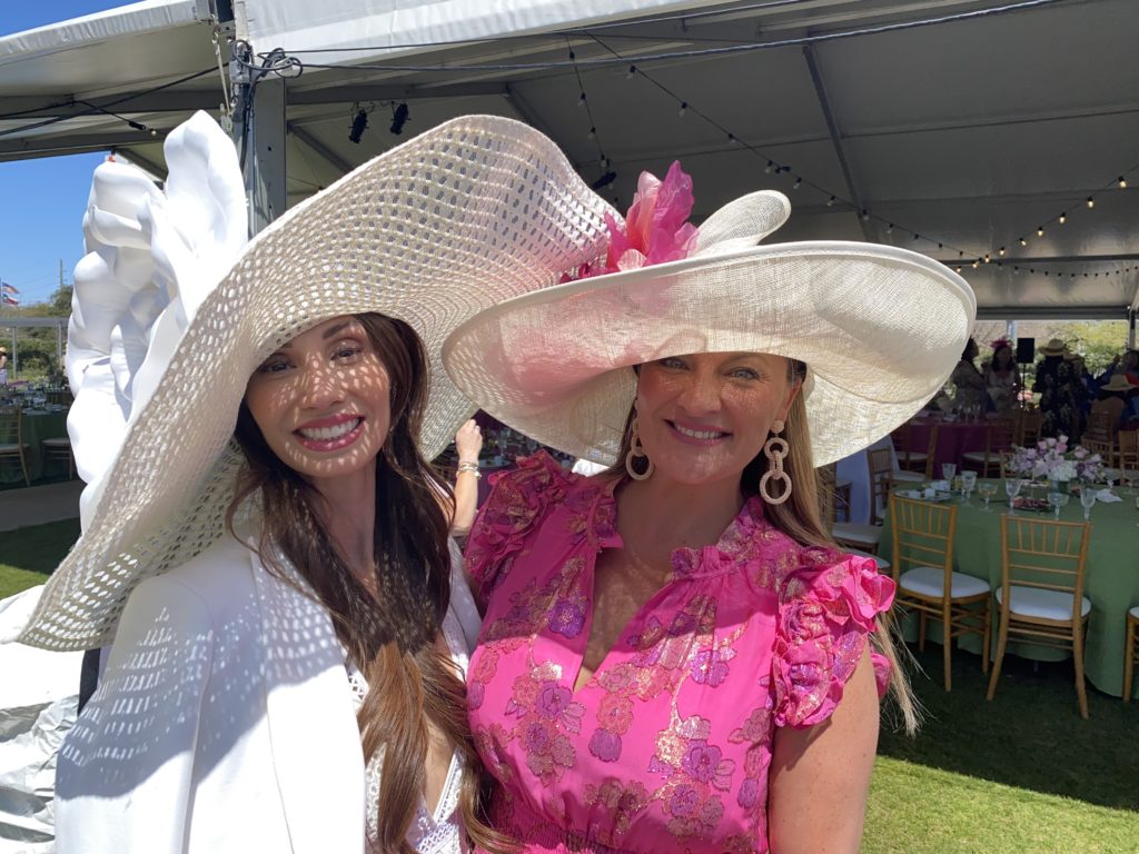 April Salazar and Rachel Regan take Hermann Park Conservancy's call of Hats in the Park very seriously with two of the largest hats on display at the annual luncheon. (Photo by Shelby Hodge)