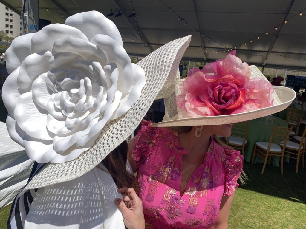 April Salazar and Rachel Regan take Hermann Park Conservancy's call of Hats in the Park very seriously with two of the largest hats on display at the annual luncheon. (Photo by Shelby Hodge)