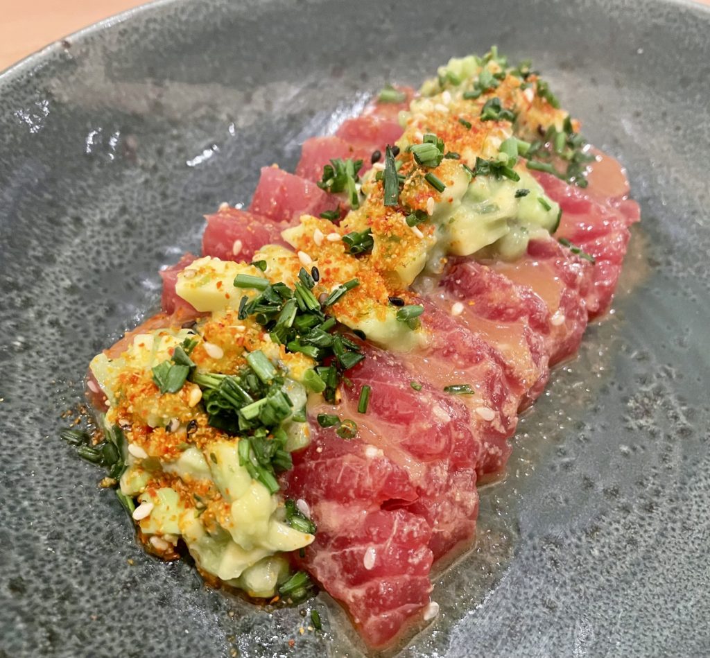 Tuna crudo is a luscious plating draped with avocado and cucumber salad. Photo by Courtney Dabney.