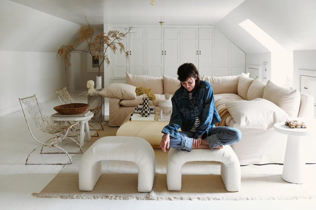 Leanne Ford in the white on white attic space she designed for her own Pittsburg home. Photo by Erin Kelly for Architectural Digest. 