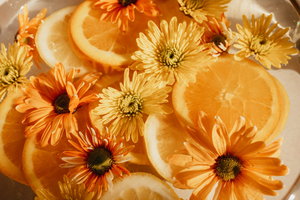Flowers and orange illustrate the flavors of Love Street Citrus (Courtesy of Karbach Brewing Co.).