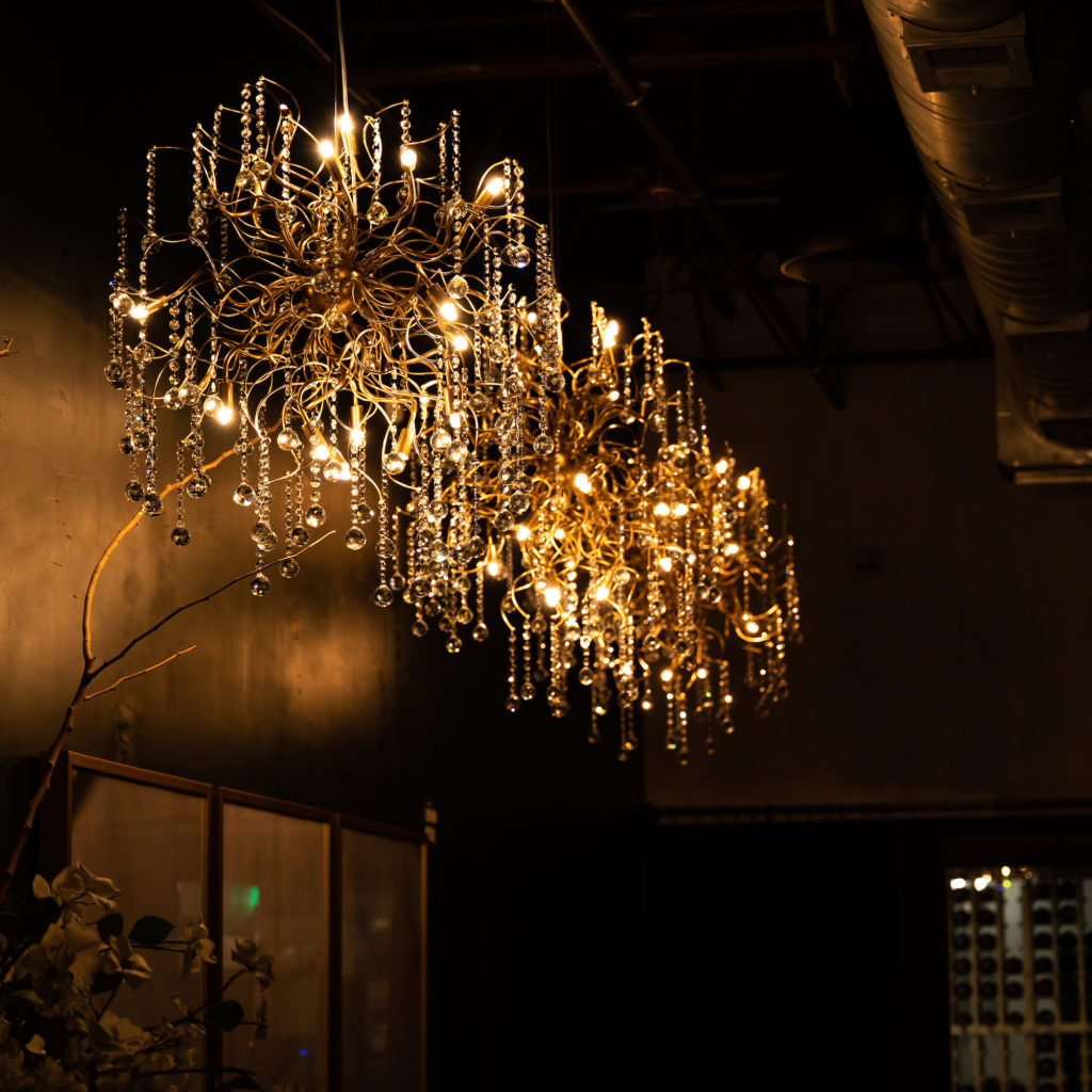 Once led to the intimate dining room tucked inside the restaurant Savior, you'll find a space lit with crystal chandeliers. Photo Barrett Doke.