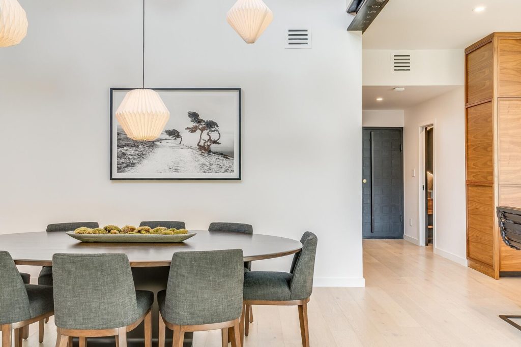 Light cascades into the dining and kitchen from walls of windows and double height ceiling.