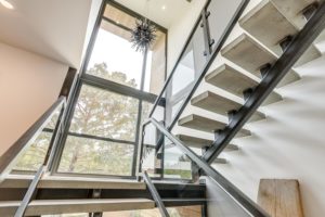 5024 Bryce – Main staircase with concrete treads, awash in sulight.