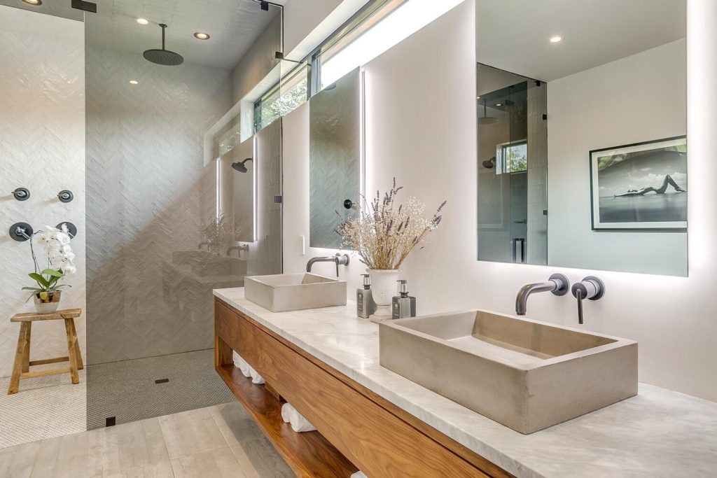 Primary ensuite with double sinks and double rain head shower.