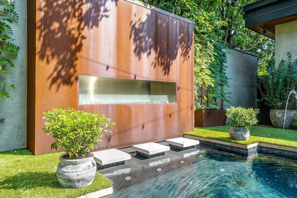 Splash fountains and outdoor fireplace make a statement.