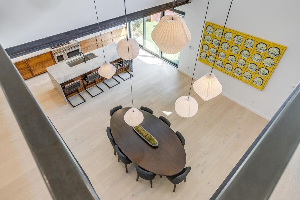 A view from the second floor into the kitchen and dining.