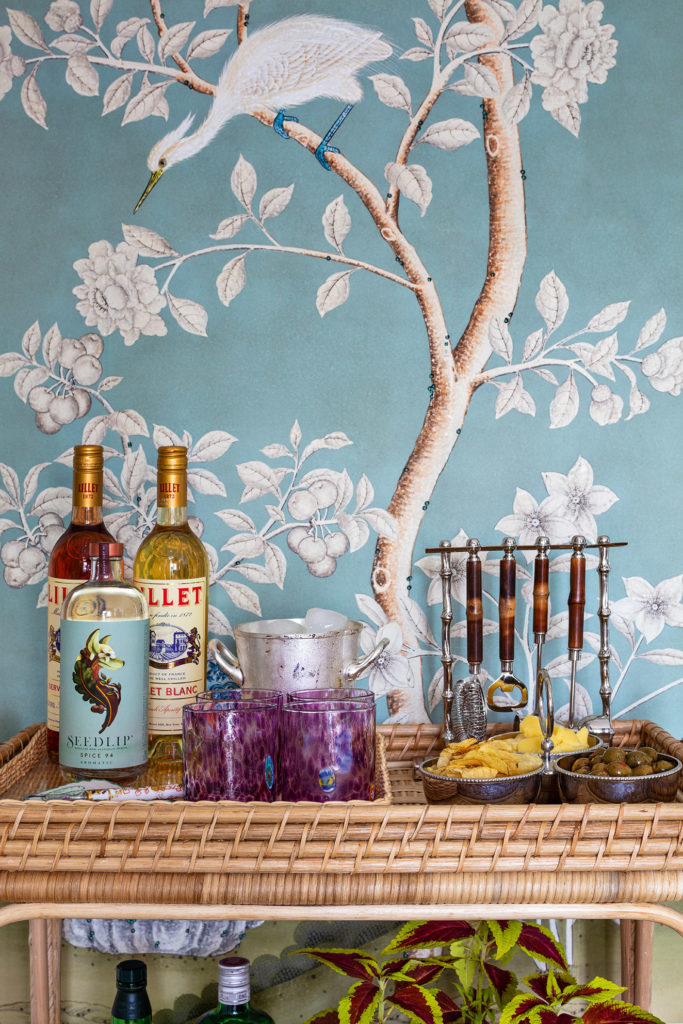 Wicker liquor cart at Ariel Okin's home, with hand-painted Gracie wallpaper.
