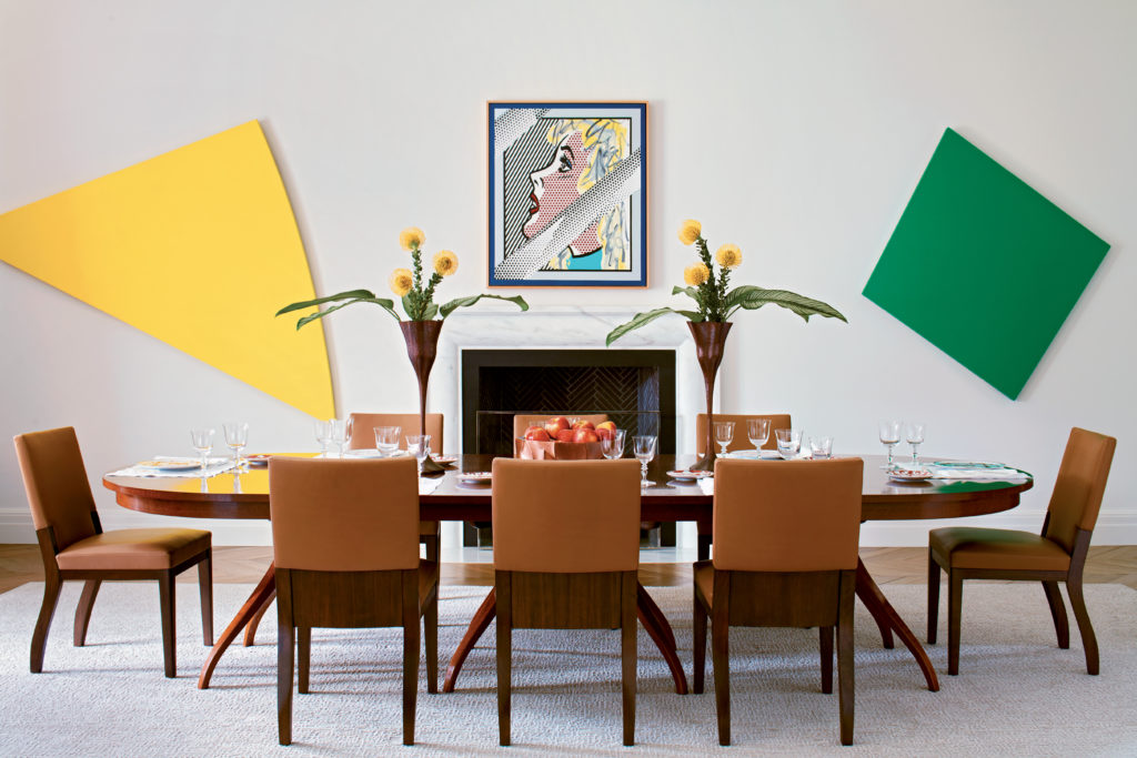 A pair of Ellsworth Kelly paintings are a graphic counterpoint to a Roy Lichtenstein portrait. The walnut dining table was custom made to seat twenty four guests, and its leaves are stored behind a purpose-built hidden panel.