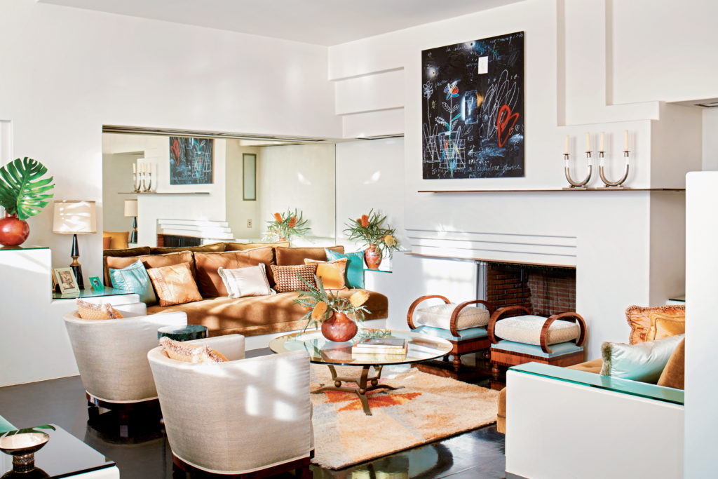 A richly hued palette that’s meant to convey a 1930s sensibility. Mirrors—like the one over the banquette—are used in many of the rooms,
ostensibly as a tribute to del Rio’s beauty. The Swedish Rya rug dates to the 1950s, but the geometric motif feels very much of the Art Deco period. The hammered-copper vessel is from the 1930s.