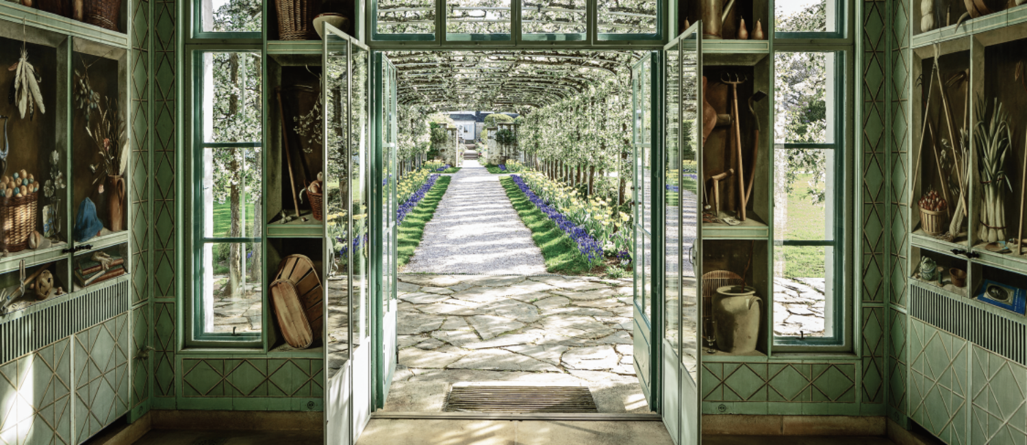 Inside the central pavilion of Bunny Mellon’s formal greenhouse at Oak Spring with Fernand Renard trompe l’oeil paintings.