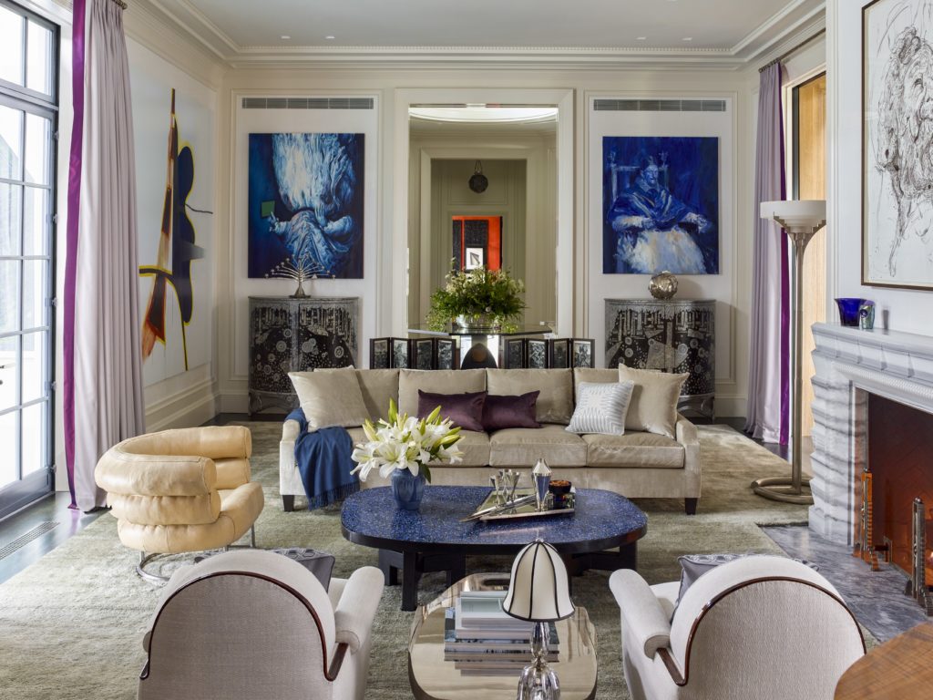 Flanking the door to the gallery, Glenn Brown’s "The Great Queen Spider" (2009) and Yan Pei Ming’s  "Innocent X Outremer" (2015) hang above a pair of black, silver, and mother- of-pearl demilune cabinets from Galerie Mougin that display a nickeled-brass candelabrum by Bruno Paul (ca. 1901) and a silver sculpture by Kevin Francis Gray (ca. 2015). The seating area includes an Eileen Gray Bibendum chair ,and a pair of Leleiere armchairs by Émile- Jacques Ruhlmann (ca. 1925) that flanks a Maria Pergay coffee table (ca. 1958), on which rests a Josef Hoffmann lamp (1923). 