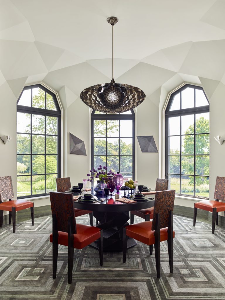 The custom silk-and-wool rug was made by V’Soske. The nailhead-studded, Oregon pine and beech chairs were designed by André Sornay (ca. 1936). The table is set with a dinner service by Steuben Glass Works (ca. 1925), violet wine glasses by Otto Prutscher (1912), a Leune vase (ca. 1925), and two Vittorio Zecchin Veronese glass vases designed for Venini/Cappelin (1925). 
