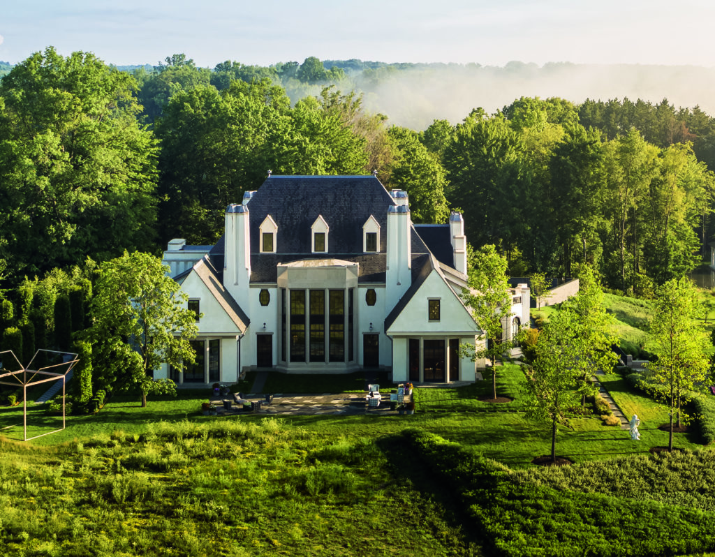 On the south façade, the chimneys and great double-height bay window of the library are commensurate with the scale of the prospect. To the east, Reed Hilderbrand’s garden design ties the house plateau to the meadow, which slopes toward the new pond. 

