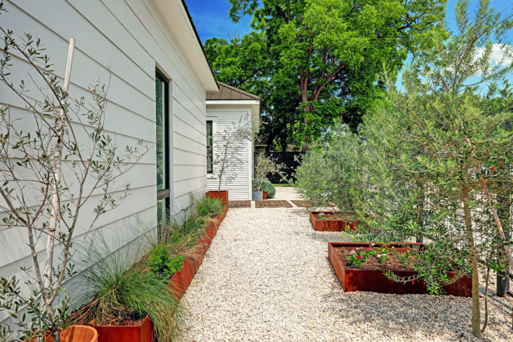 Side yards at 717 East 21st St. are covered in white limestone gravel (Photo by TK Images)