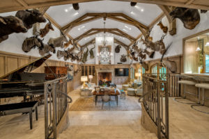 2710 – Architectural beams top the great room lined with safari trophies.