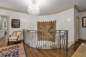 2710 – Custom iron staircase lined with Venetian plaster walls lead to the second floor landing.