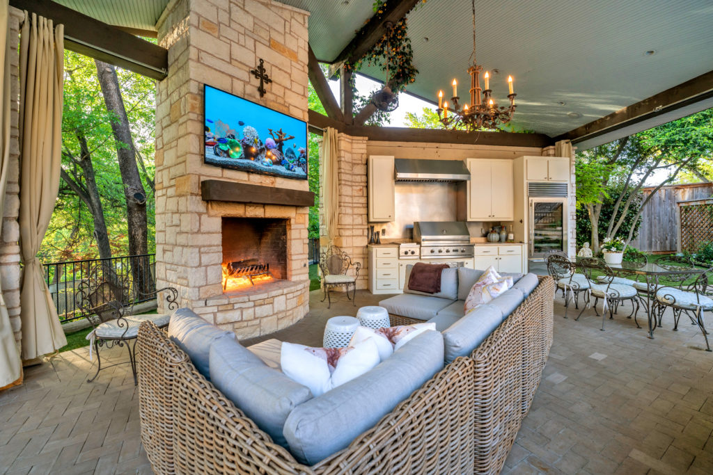 Outdoor living in the cabana with full kitchen, fireplace and entertainment.