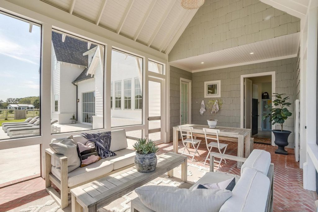 Relax in the screened porch with wrap around views of the property.