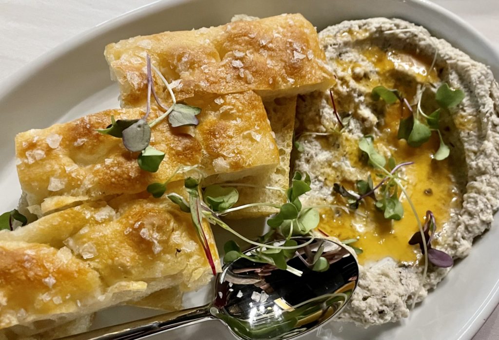 Cold-fermented focaccia alongside truffled ricotta spread and Calabrian honey. Photo by Courtney Dabney