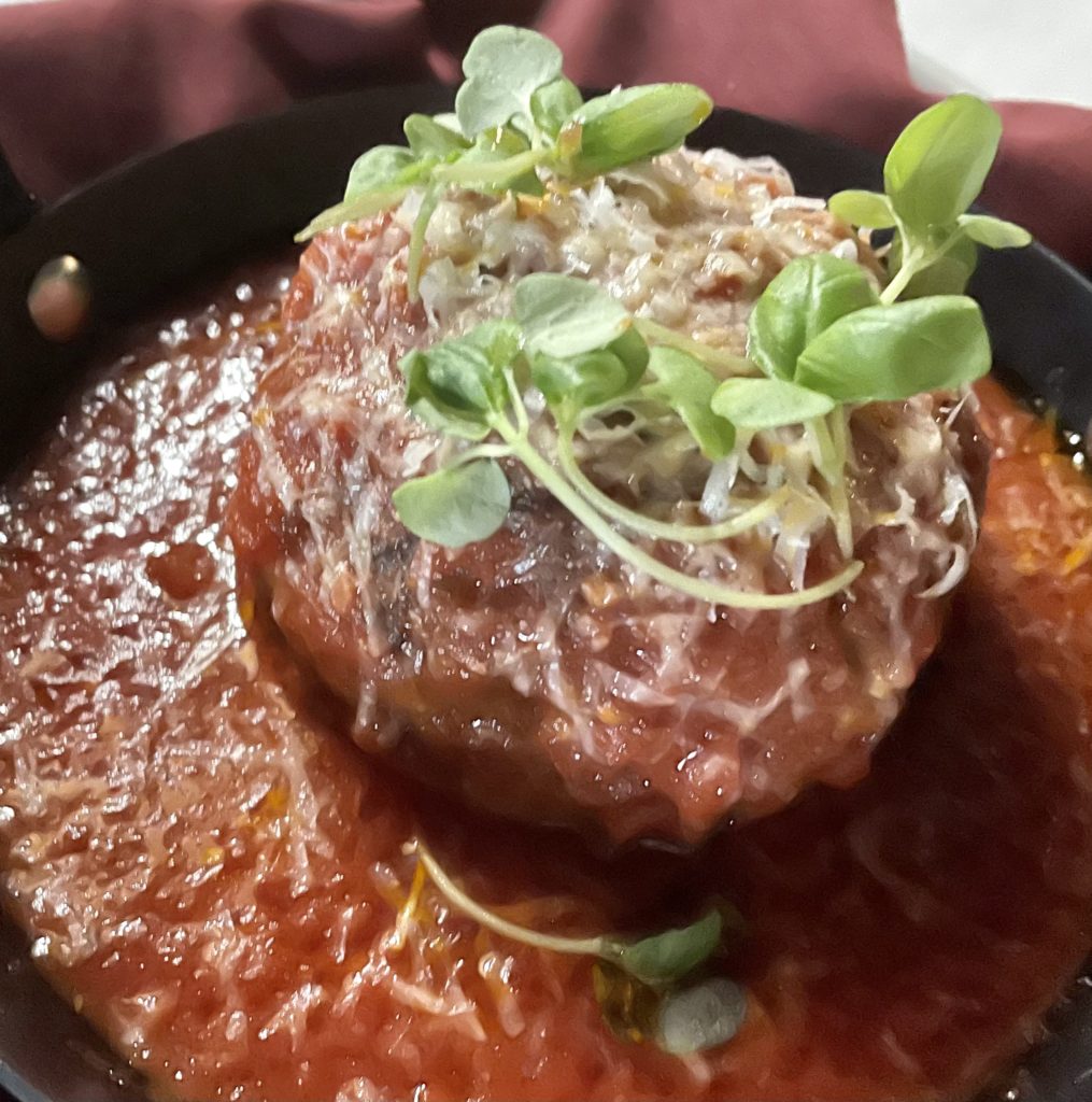The pork and veal meatball topped with microgreens and pecorino cheese. Photo by Courtney Dabney.