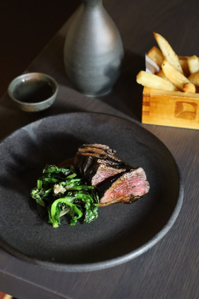 Uchiko's charred onion aged Bar n Ranch beef is seared four times and served with french fries fried in A5 beef tallow. (Courtesy of Hai Hospitality )
