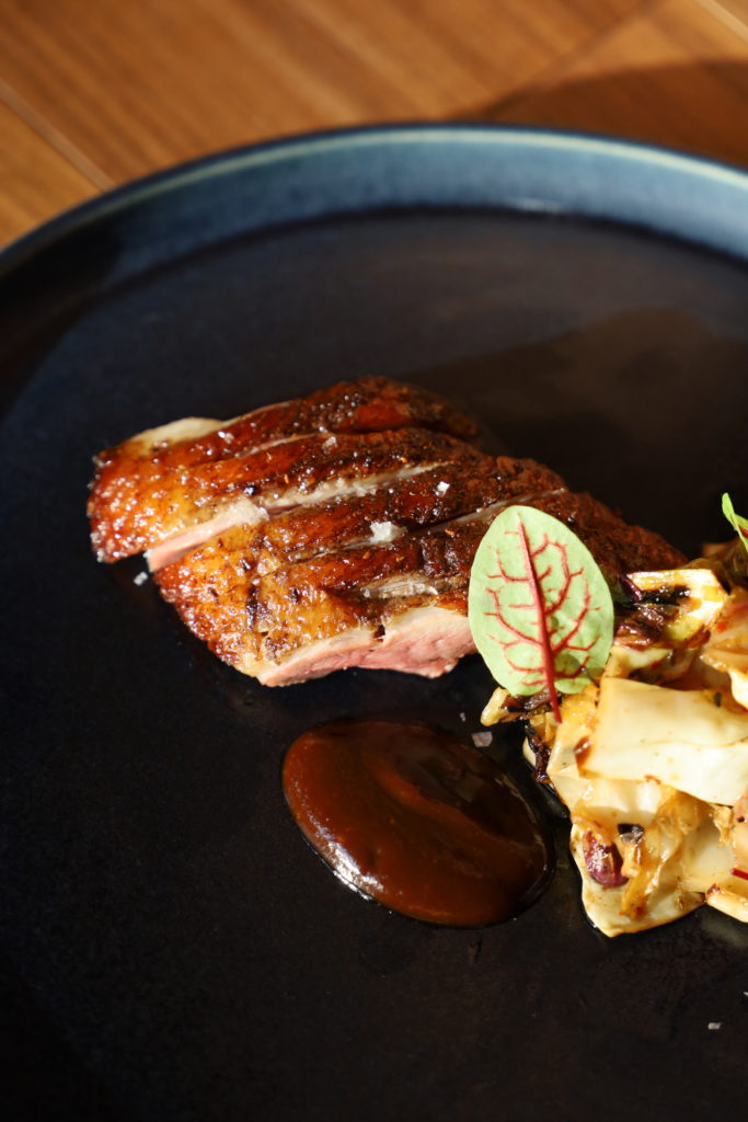 One of Uchiko's signature hot tasting dishes is the dry aged duck served with a house made hoisin sauce and a dashi braised and hearth roasted cabbage. (Courtesy of Hai Hospitality) 