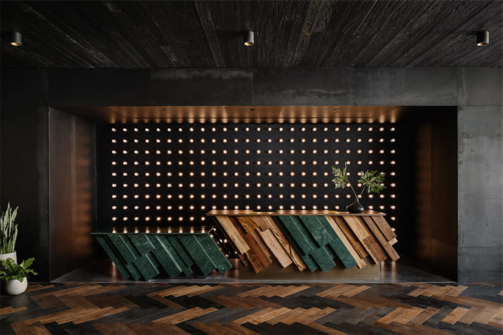 Thompson Austin's front desk is inspired by raw cut gemstones and a shou sugi ban wood ceiling finish. (Photo by Chase Daniel)