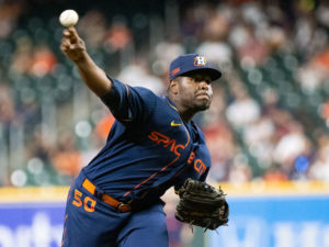 Houston Astros outfielder Yordan Alvarez, flanked by Astros general Manager James Click and a Spanish translator, announced a 6-year, $115 million contract extension that keeps the young Cuban slugger an Astro through 2028, at a Minute Maid Park news conf