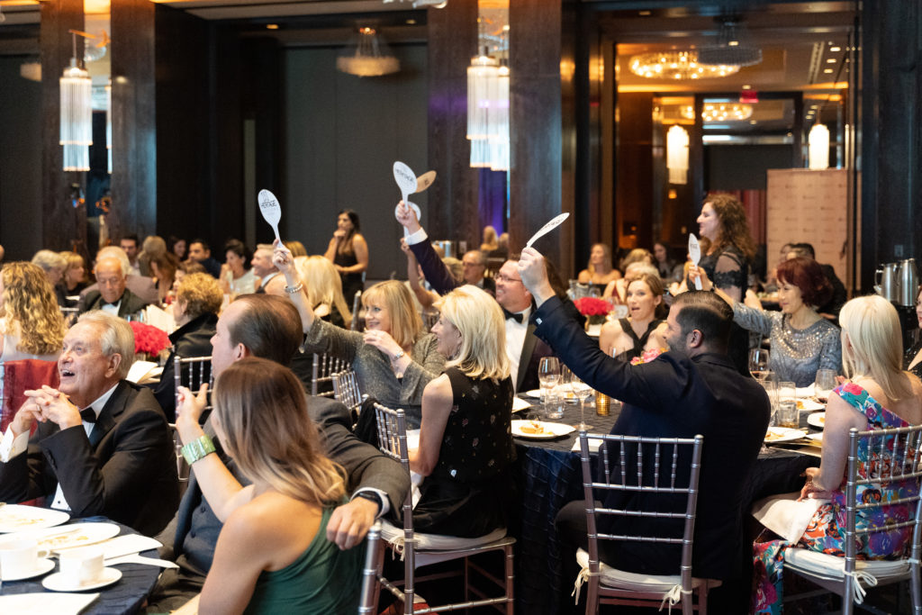 Auction paddles at the ready (photo by Scott Hagar)