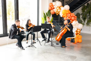 Divi Strings performs at Nancy Almodovar's birthday brunch at Nan & Company Properties flagship office (Photo by Nan Studios) (Photo by Nan Studios)