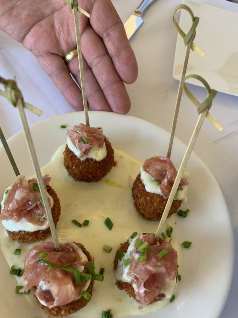 Potato croquettes crowned with Jamon serrano poised on a pool of truffle cream. (Photo by Laurann Claridge)