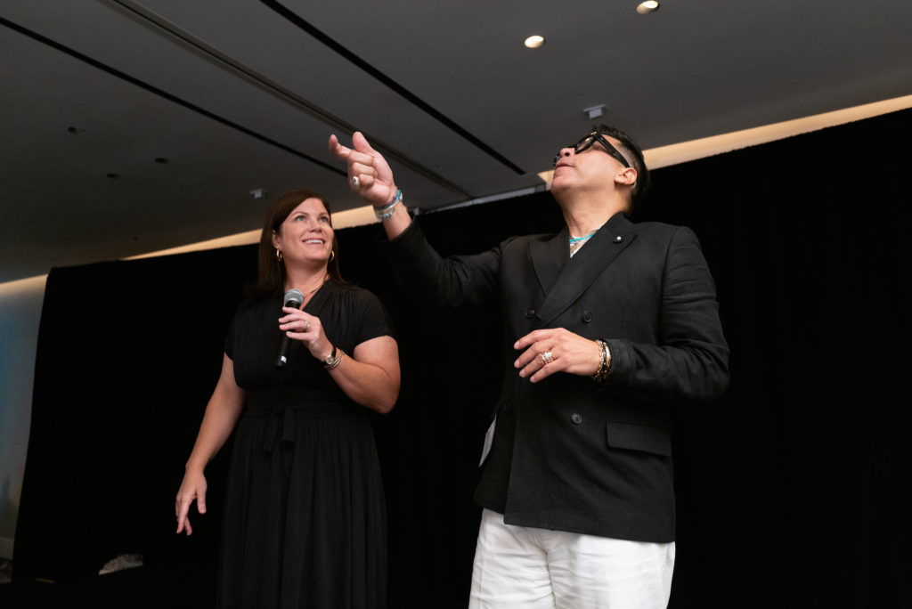 Lauren Levicki Courville, Jay Landa flipping the Heads or Tails coin during the Dress for Success Houston event at the Four Seasons Hotel. (Photo by Daniel Ortiz)