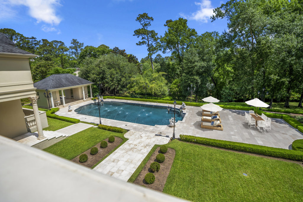 A second floor view to the pool and gardens at 3920 Inverness (Photo by Turnkey Visuals LLC)
