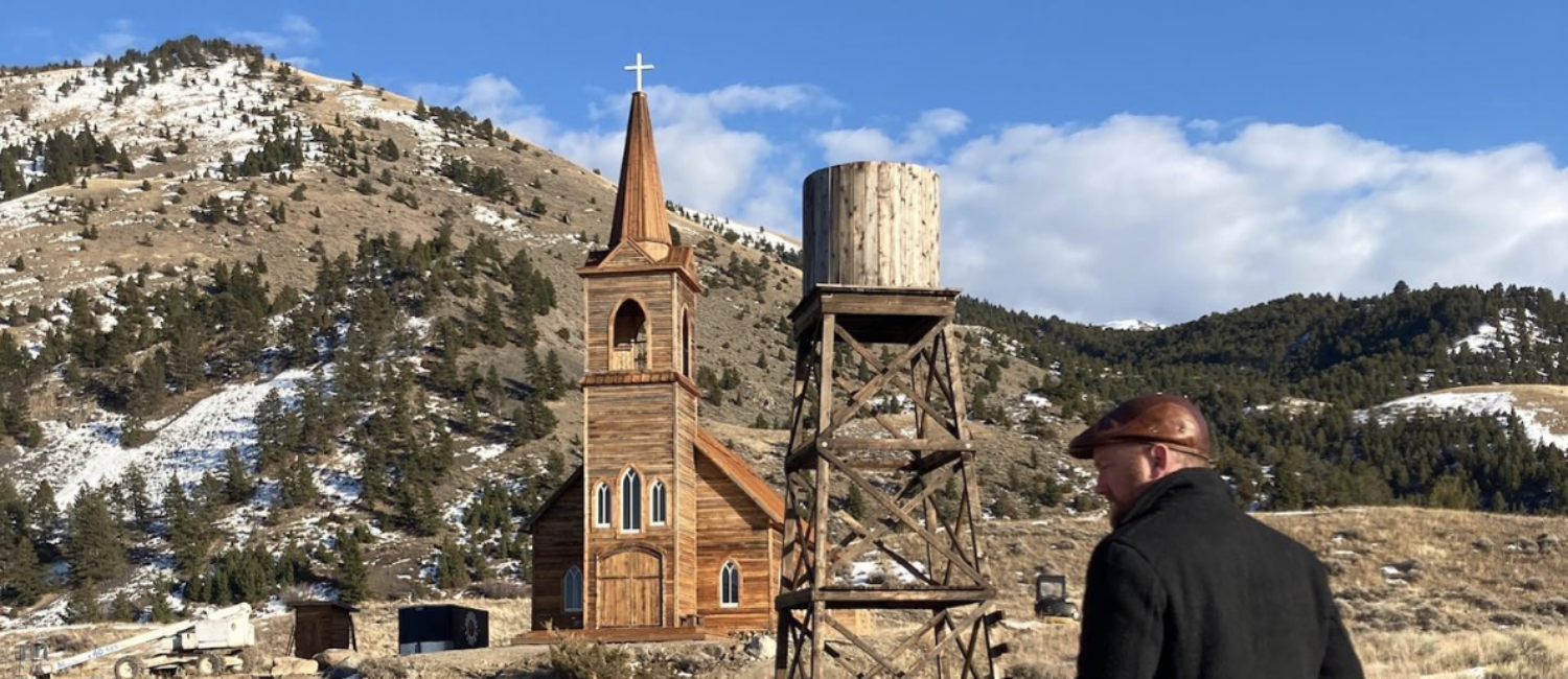 Director Richie Gray searches for an angle on the set of Murder at Yellowstone City.