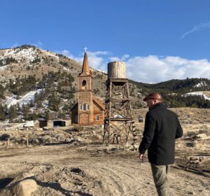 Director Richie Gray searches for an angle on the set of Murder at Yellowstone City.