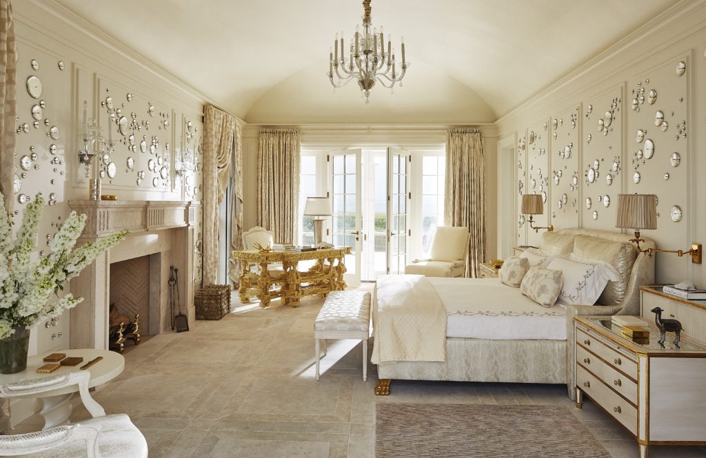 In the bedroom of a Bridgehampton beachside home, Rob Wynn bubbles dapple the walls of the main bedroom, which has a Venetian-glass chandelier and a desk by Chris Schanck Studio. (Photo by William Abramowicz)