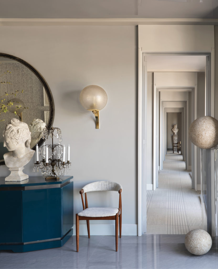 On Paris’ Left Bank, at the intersections of the grand Esplanade des Invalides and the opulent Pont Alexandre III, are the new headquarters of Jean-Louis Deniot in a residential building that was once the home of Hubert de Givenchy and designer Charles Sevigny. Pair of vintage girandoles with crystal pampilles. Plaster Diane de Poitiers bust; pair of armchairs by Johannes Andersen in Boussac. Lacquered sideboard by Guy Lefevre for Maison Jansen; set of four 1950s ball wall lamps. Mirror by Collection Pierre. (Photo by Stephan Julliard)