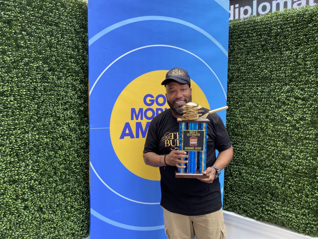 Bun B hoists up his golden burger trophy as he takes first prize in the nationwide burger competition hosted by Good Morning America.