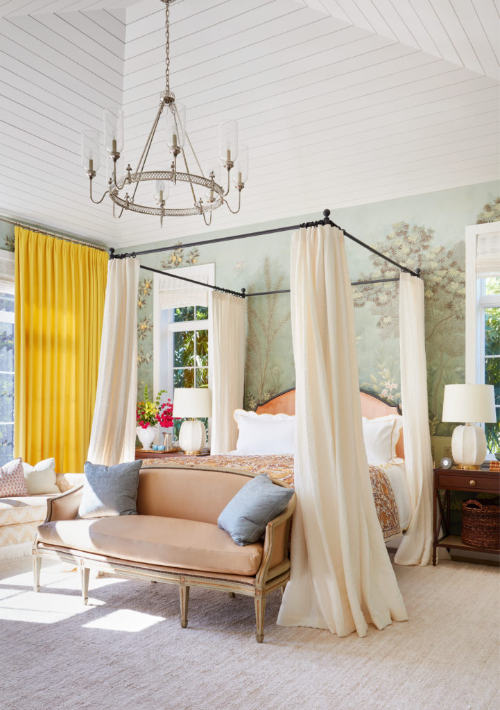 In a Naples, Florida, escape, Summer Thornton created a fantasy  bedroom, pushing the limit with yellow wool cashmere curtains and a scenic lemon-grove panorama wallcovering from Gracie. (Photo by Thomas Loof)