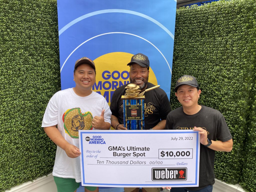 Trill Burgers partners Andy Nguyen and Bun B with chef Mike Pham and the Golden Burger Trophy awarded by Good Morning America.