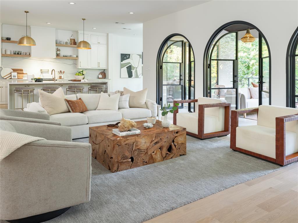 Three impressive arched steel doors open to a striking covered patio. 