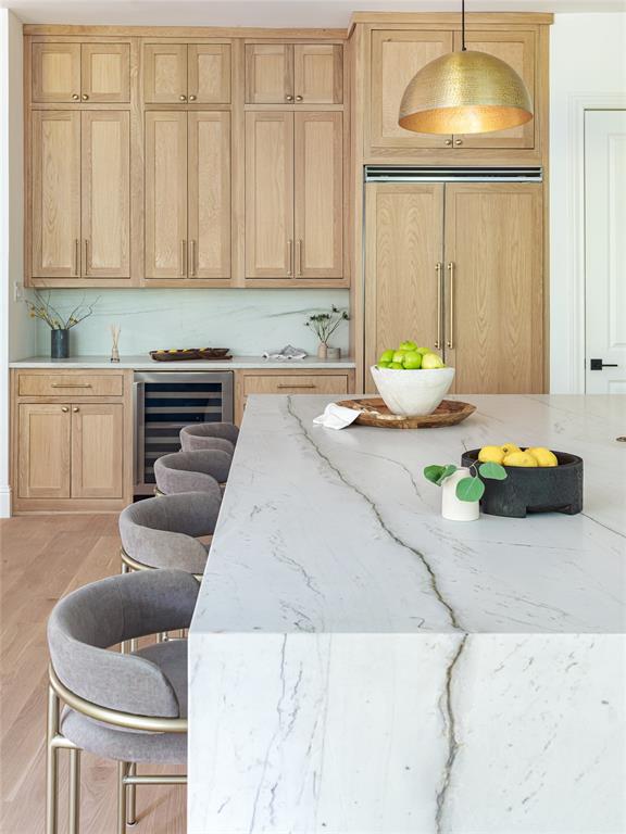 A white oak paneled refrigerator in the 2022 new build.