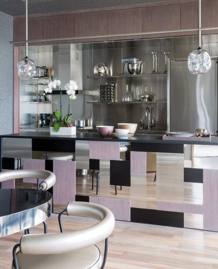 In the New York City Annabelle Selldorf-designed building, a bar is custom-designed by Jean-Louis Deniot in marquetry of polished stainless steel, brushed stainless steel, ash-stained teak and ebony-stained teak, top and sides in brushed black granite. Custom-designed JLD pendant lights with glass globes by John Pomp