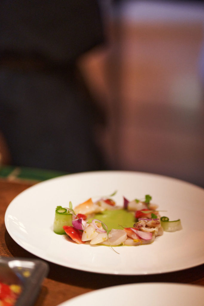 The six course tasting menu started with citrus cured chocolate clams and scallops in a green aquachile sauce. (Photo by Studio Caribe)