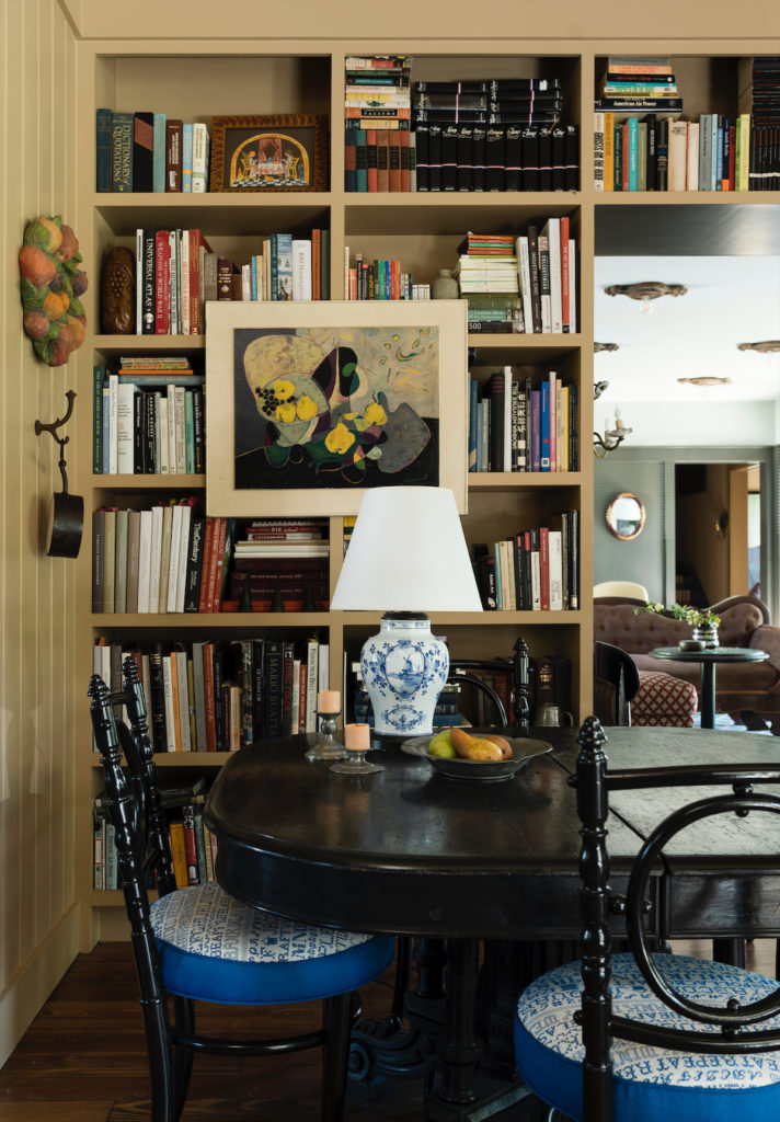 Napoleon III ebonized table doubles as a workspace and dining table in the library. Embroidered Pollack fabric on the chairs is reminiscent of an American alphabet sampler. (Photo by Jack Thompson)