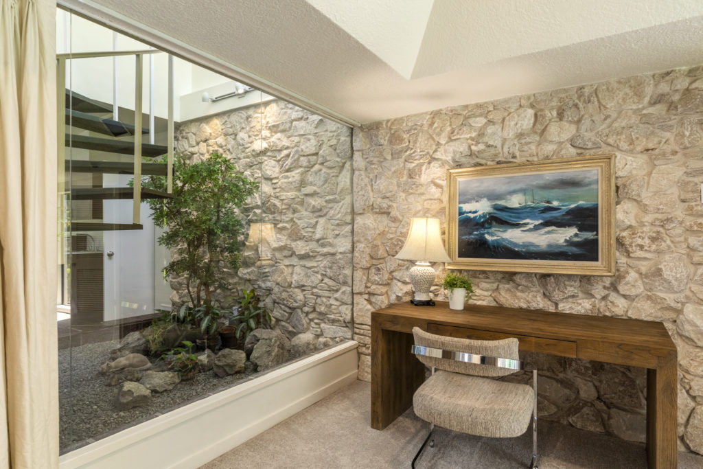 The addition of a second floor bedroom at 503 Timber Terrace Road necessitated a staircase, in this case a spiral. (Photo by Nan Studios)